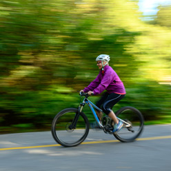 woman riding bike on road